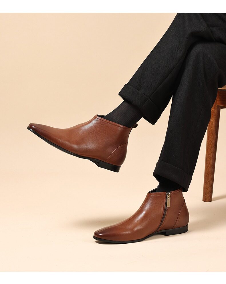Brown leather ankle boots with side zippers and thick soles.