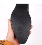 Black boot outsole with raised floral pattern tread