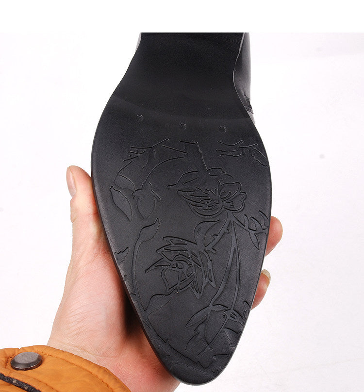 Black boot outsole with raised floral pattern tread