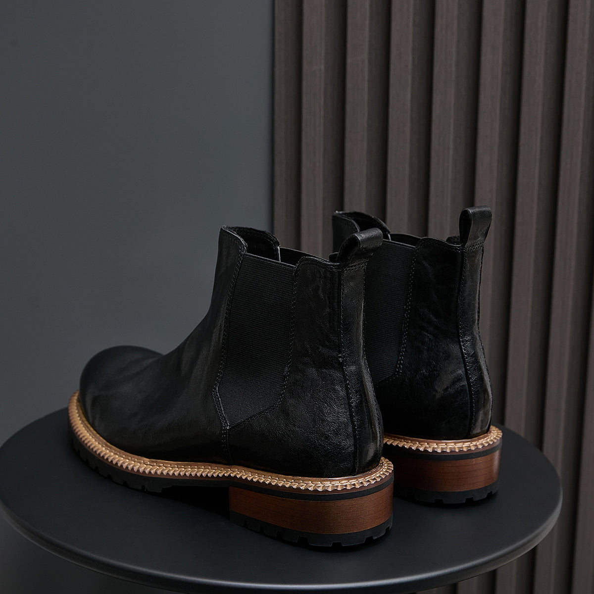 Men's black pointed-toe suede Chelsea boots, elastic side panels, tan welt sole trim