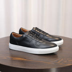 Black leather sneakers, three-quarter view, lace-up with stitched panels and sole