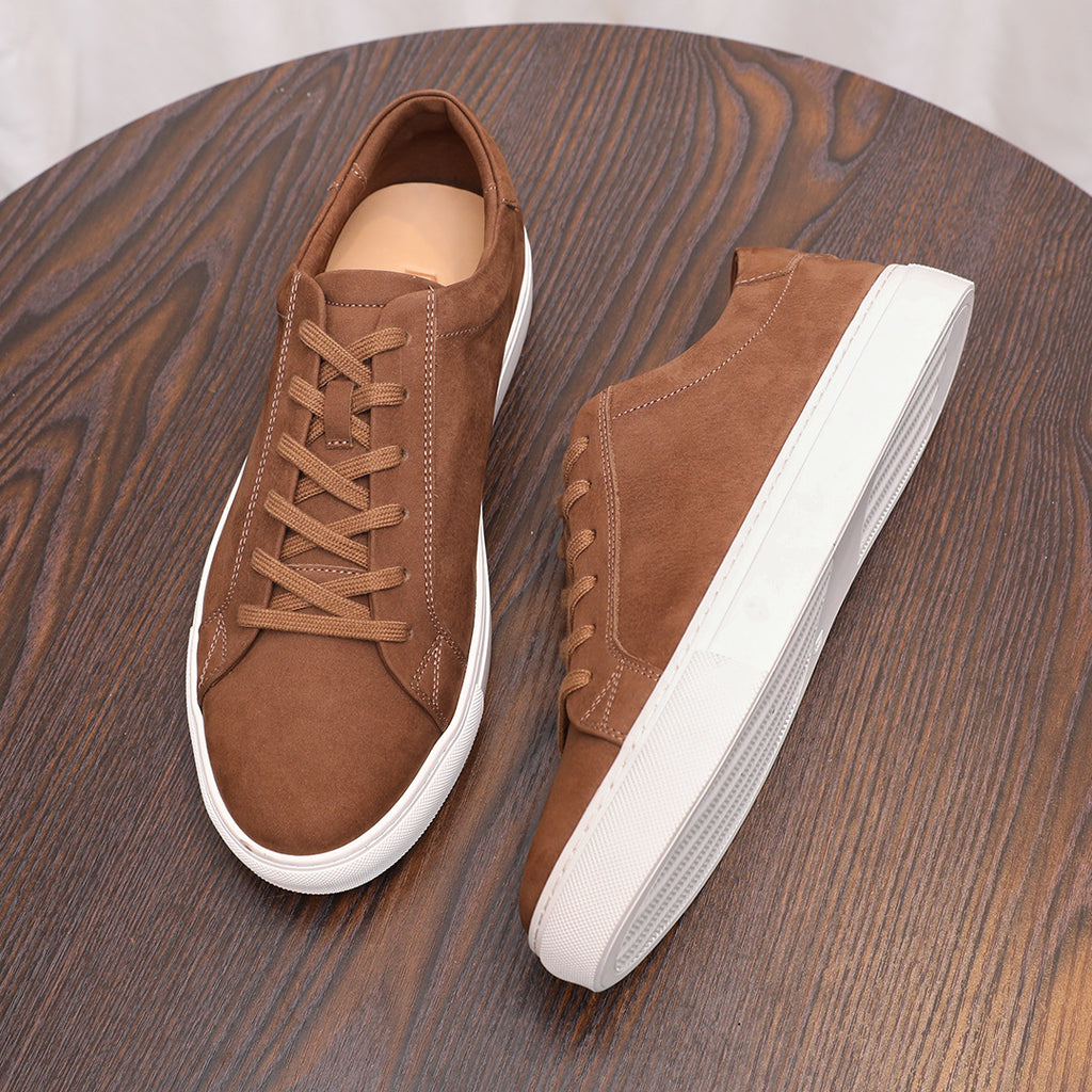 Cocoa brown suede leather sneakers with lace-up front and white rubber sole.