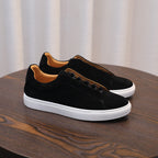 Men's black suede leather sneakers with white rubber sole and lace-up design.