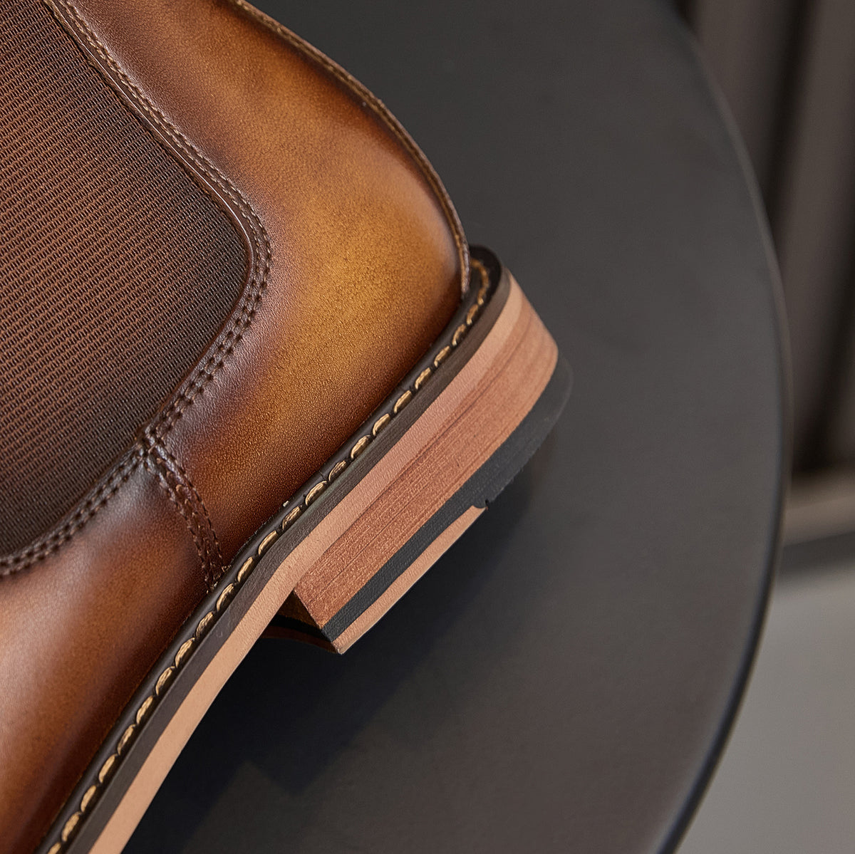 Men's suede chelsea boot outsole detail, brown with contrast stitched edge