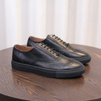 Men's black leather casual sneakers with lace-up closure and low white sole edge