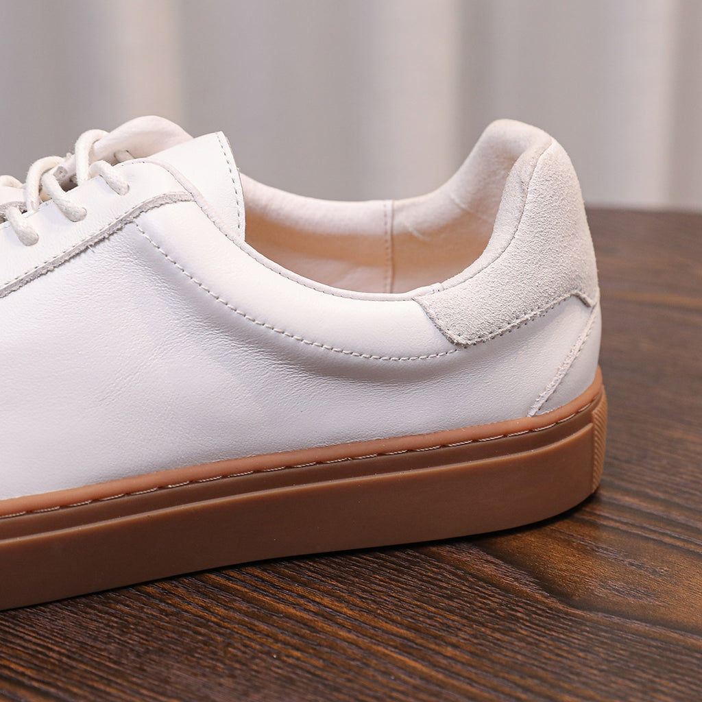 White genuine leather sneaker side with lace-up, padded collar, and tan rubber sole