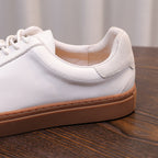 White genuine leather sneaker side with lace-up, padded collar, and tan rubber sole