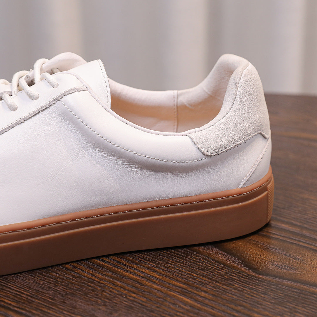 White genuine leather sneaker side with lace-up, padded collar, and tan rubber sole