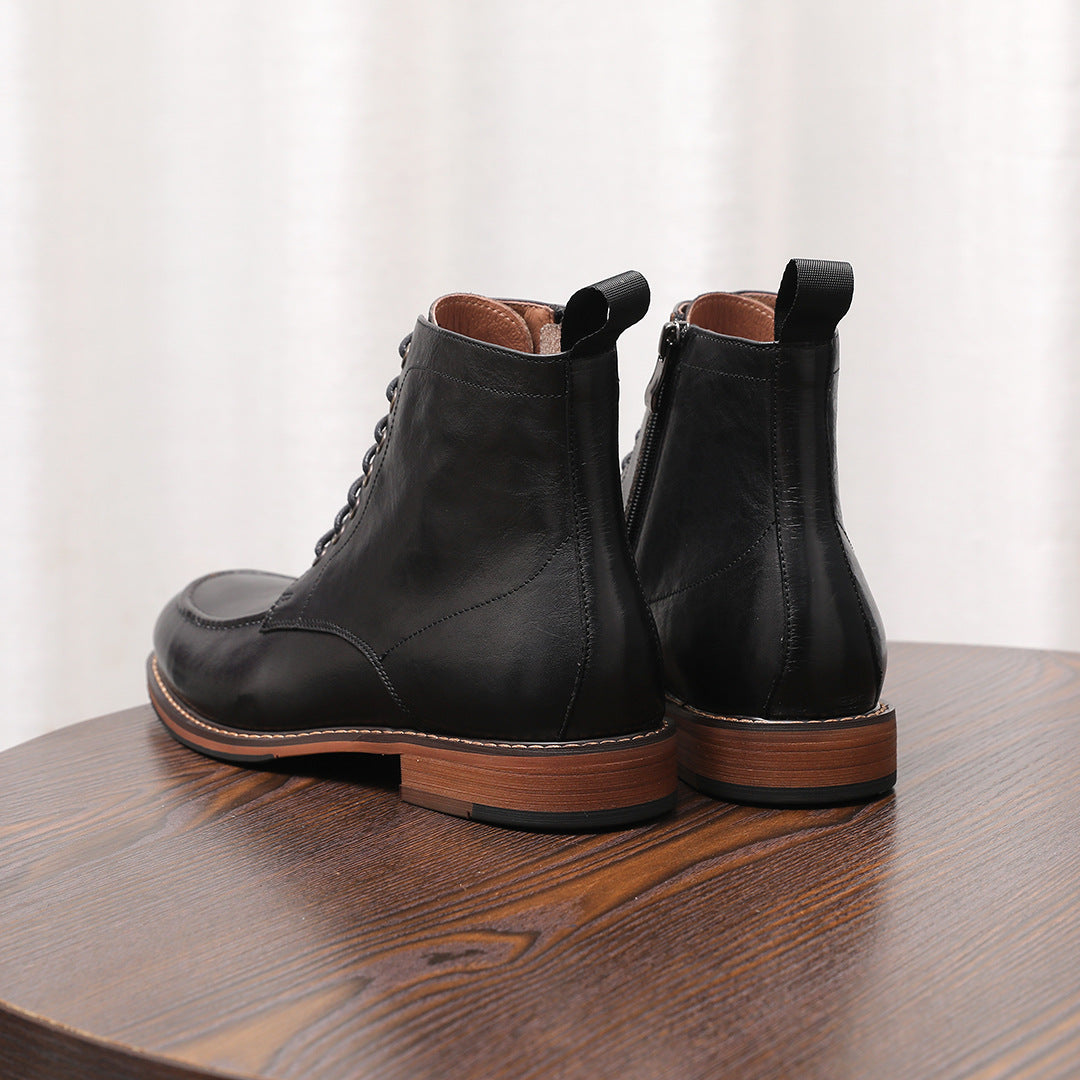 Pair of black leather side-zip dress boots with pointed toes and lace-up fronts