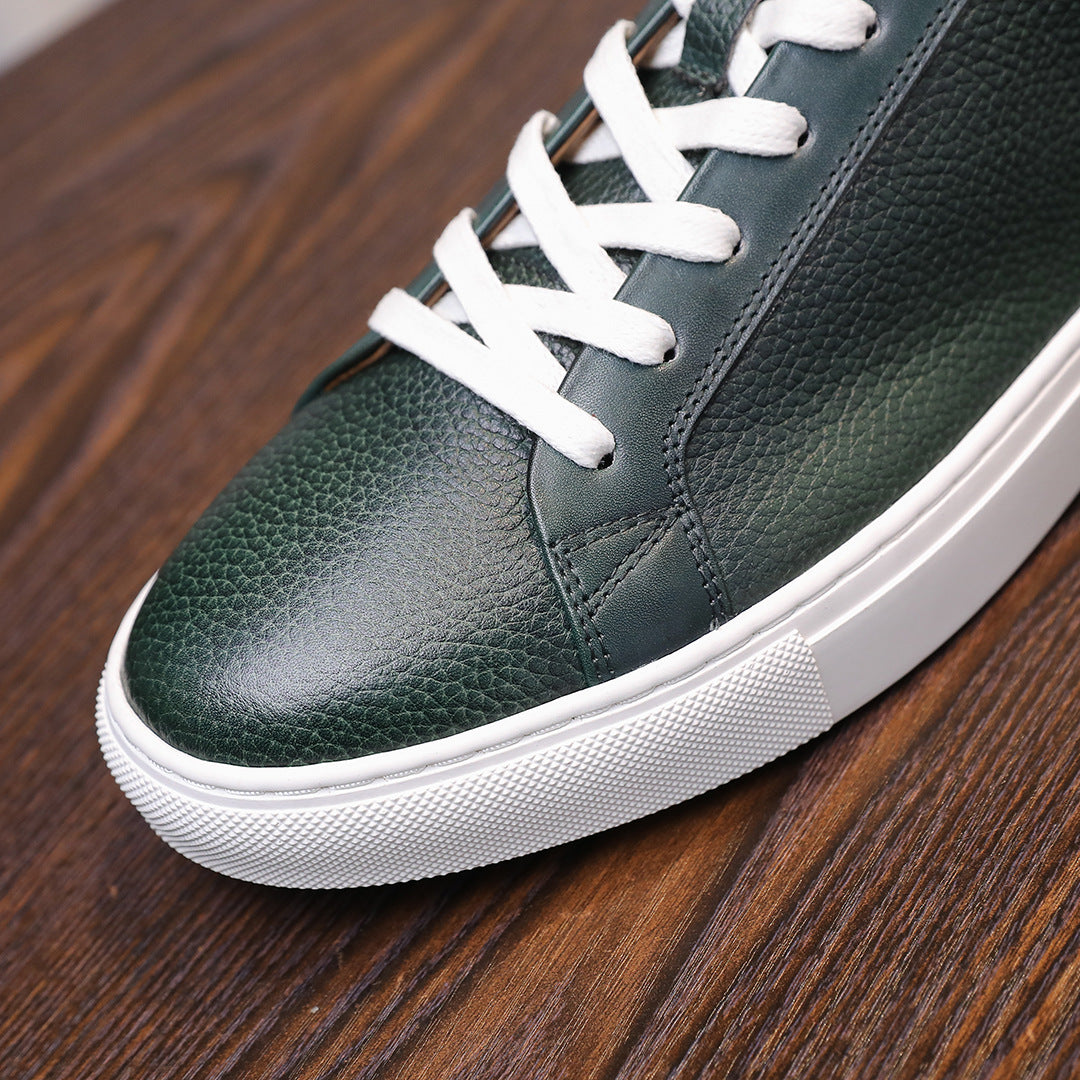 Close-up of green leather lace-up sneakers with white stitching and white rubber sole