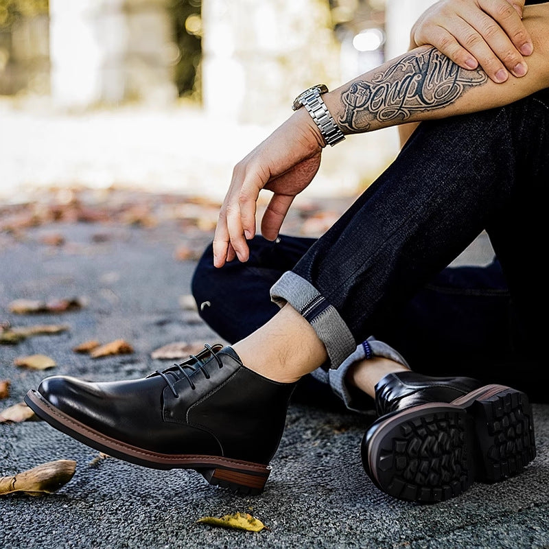 Black men's leather chukka boots, lace-up front with rugged sole visible from side.