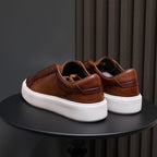 Men's brown leather sneakers heel view with white platform sole