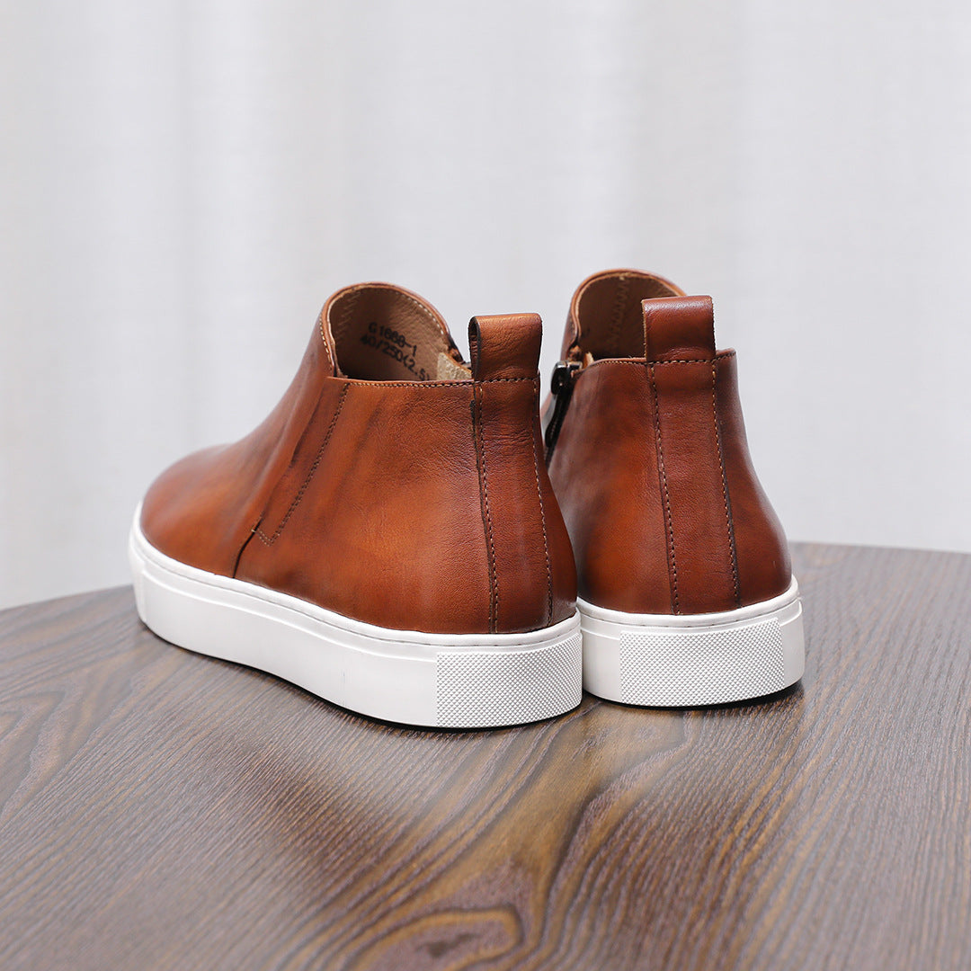 Brown leather pointed-toe dress boots with side zippers and white rubber soles