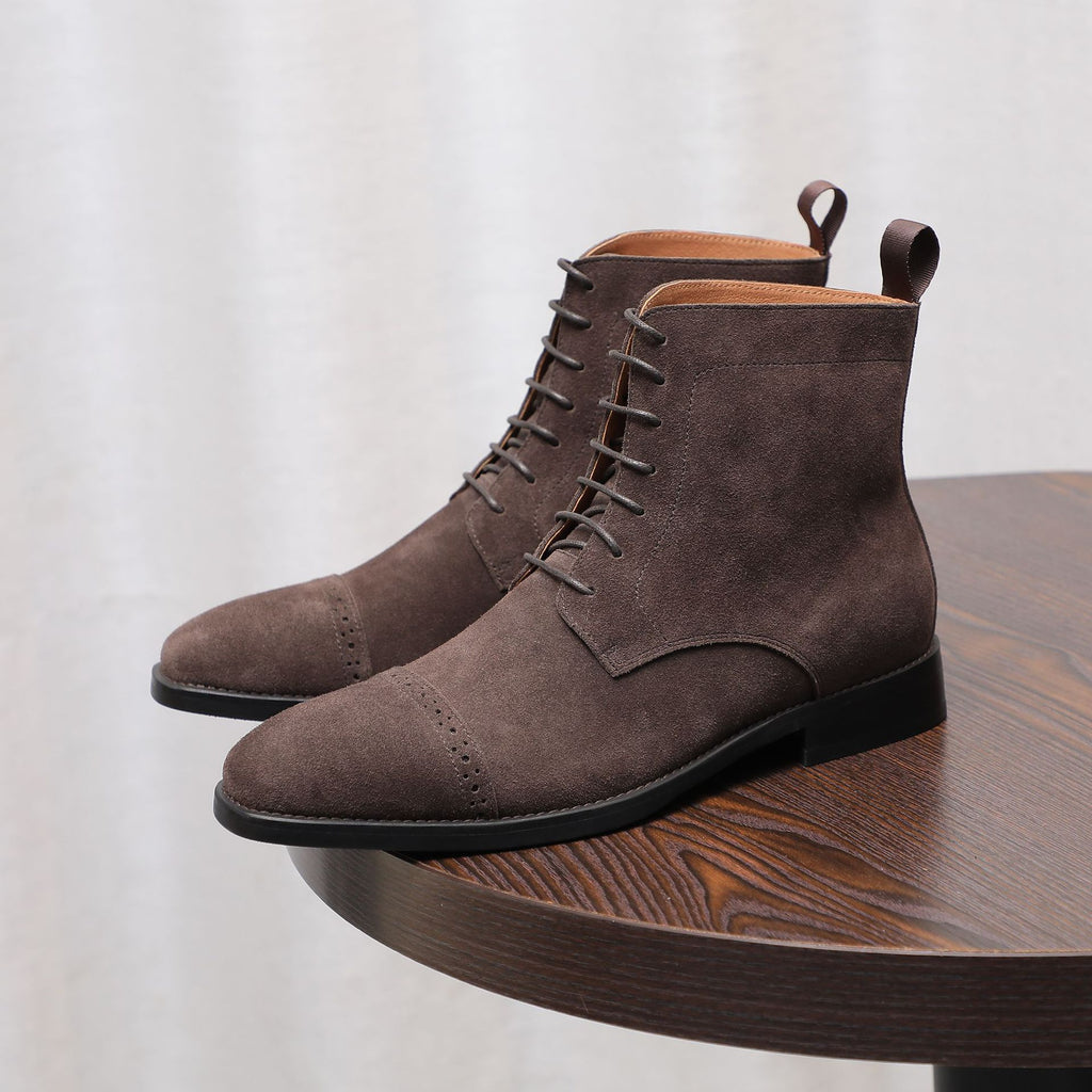 Men's dark brown suede chukka boots with plain toe, lace-up front, and black sole