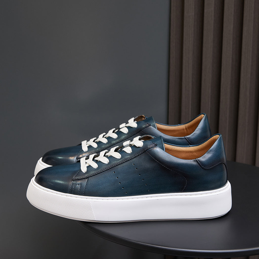 Men's dark blue leather lace-up sneakers with white rubber sole and minimal stitching