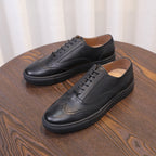 Men's black leather sneakers with lace-up front and minimal stitching