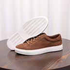 Brown suede leather sneaker shown with treaded white outsole and lace-up upper.