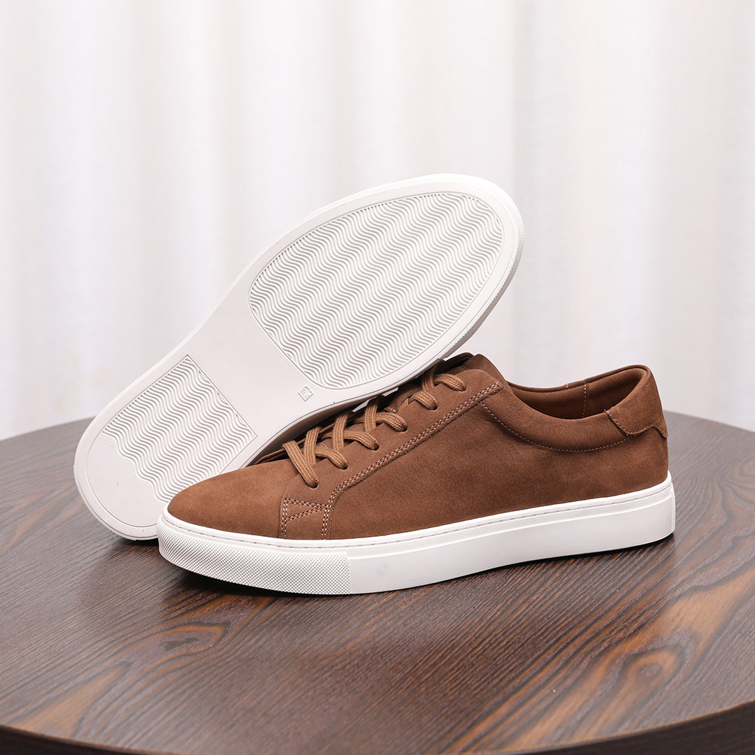 Brown suede leather sneaker shown with treaded white outsole and lace-up upper.