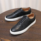 Men's black leather lace-up sneakers with white rubber sole and minimal stitching