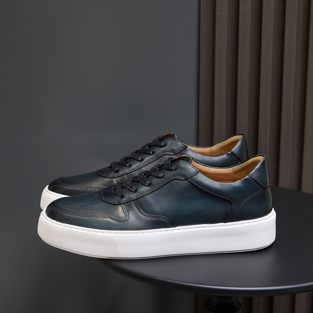 Men's dark green leather sneakers with black laces and cushioned white sole platform