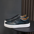 Men's dark green leather sneakers with black laces and cushioned white sole platform