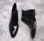 Black leather side-zip dress boots, pointed toe, sleek ankle-height profile