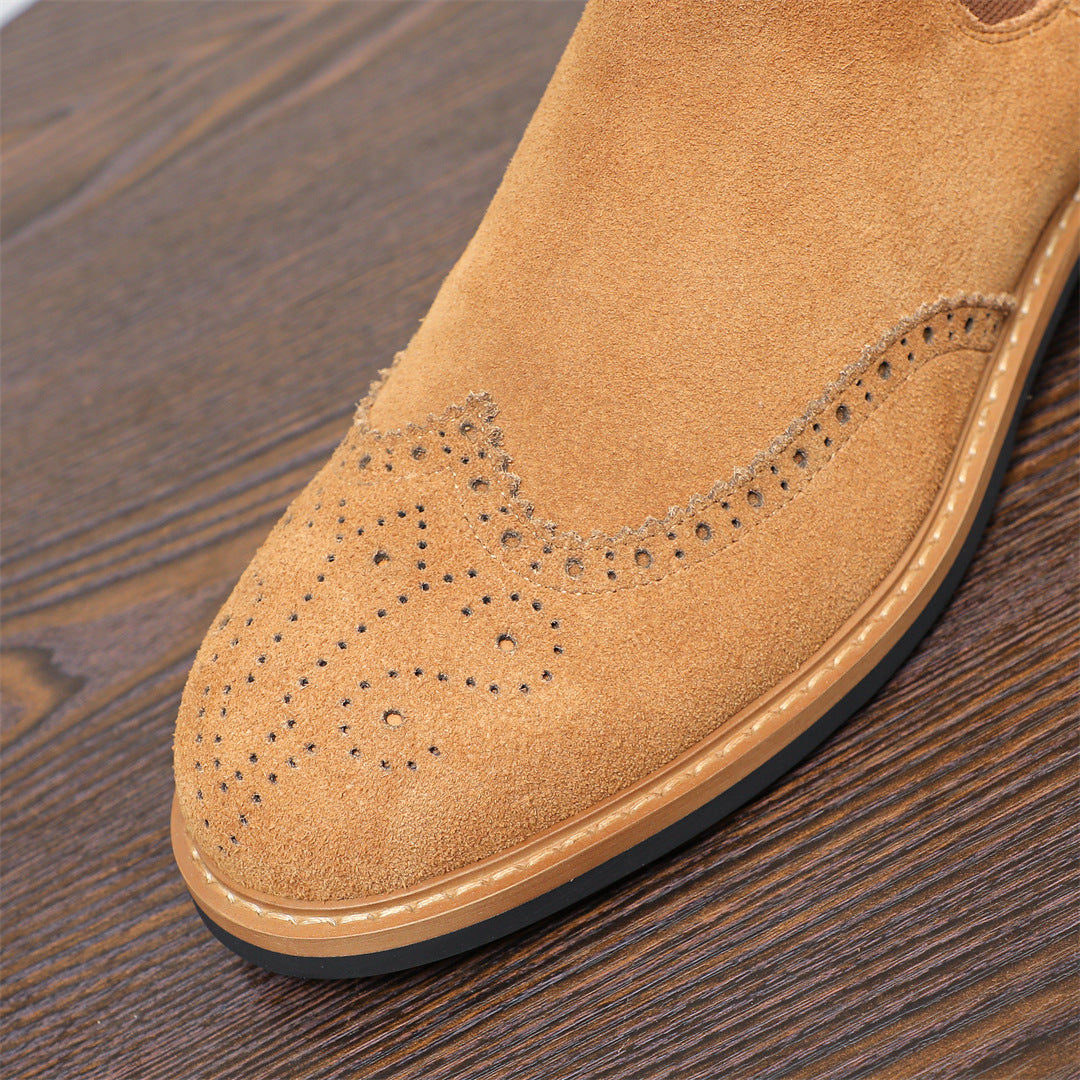 Close-up of brown suede pointed toe with brogue-style perforation and rubber sole edge