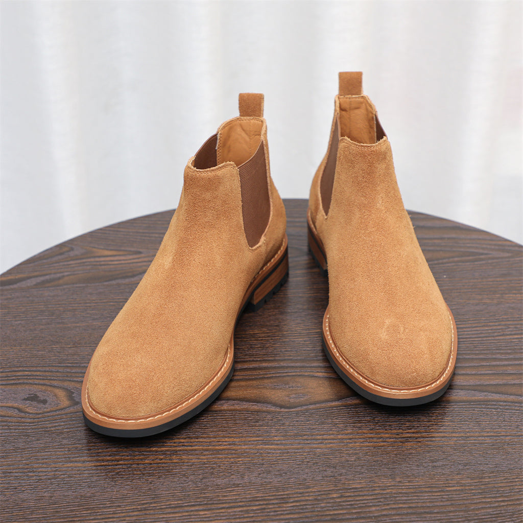 Tan suede pointed-toe Chelsea boots with elastic side panels and padded ankle collar.