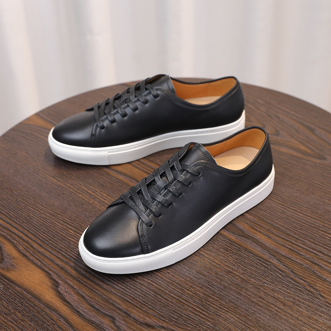 Men's leather sneakers, black low-top lace-up shoes with white midsole edge.