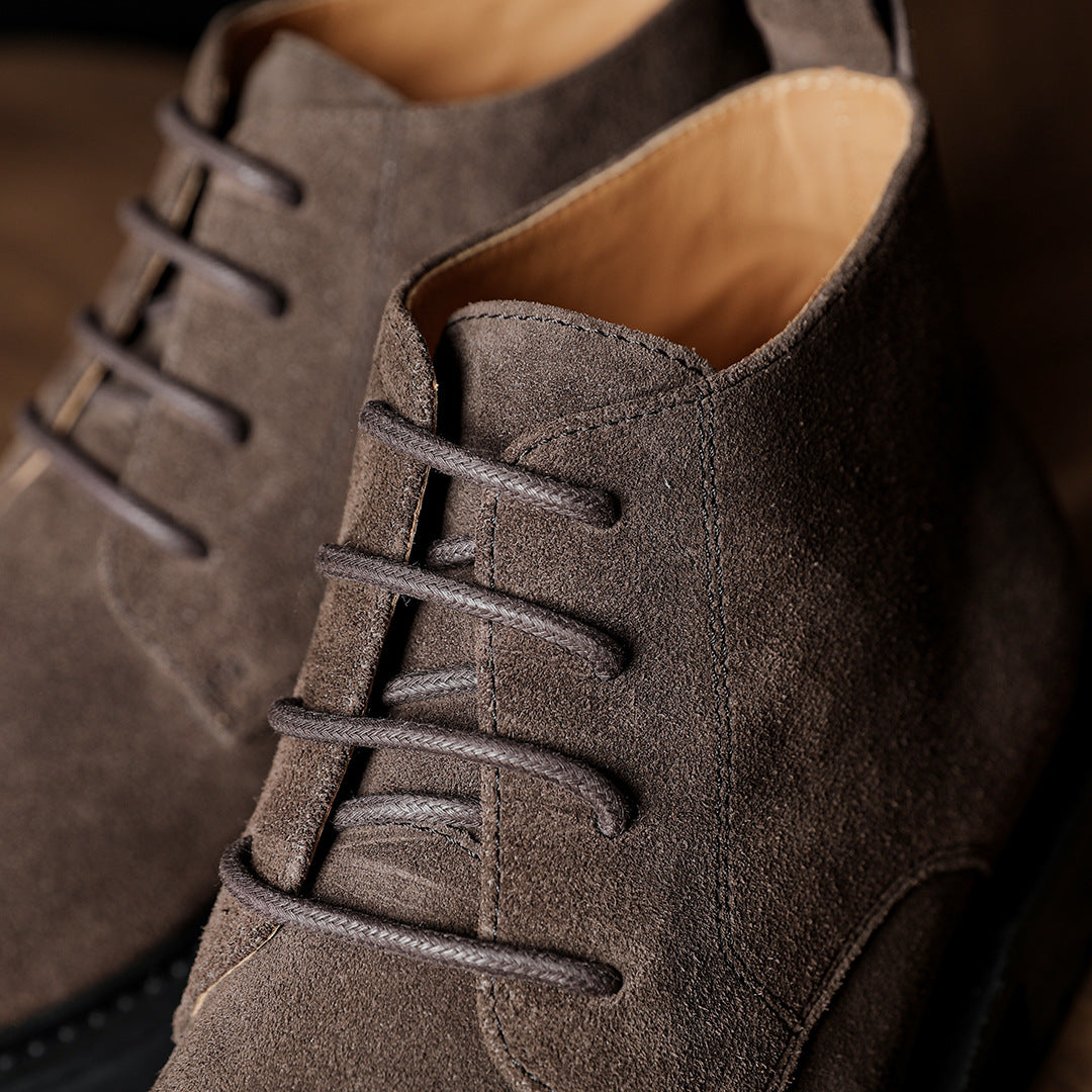 Men's dark brown suede chukka boot with lace-up front and padded collar