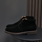 Men's black suede chukka boots with lace-up closure, plain toe, and rubber sole