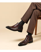 Men's genuine leather Chelsea dress boots worn with dark pants, slip-on ankle style.