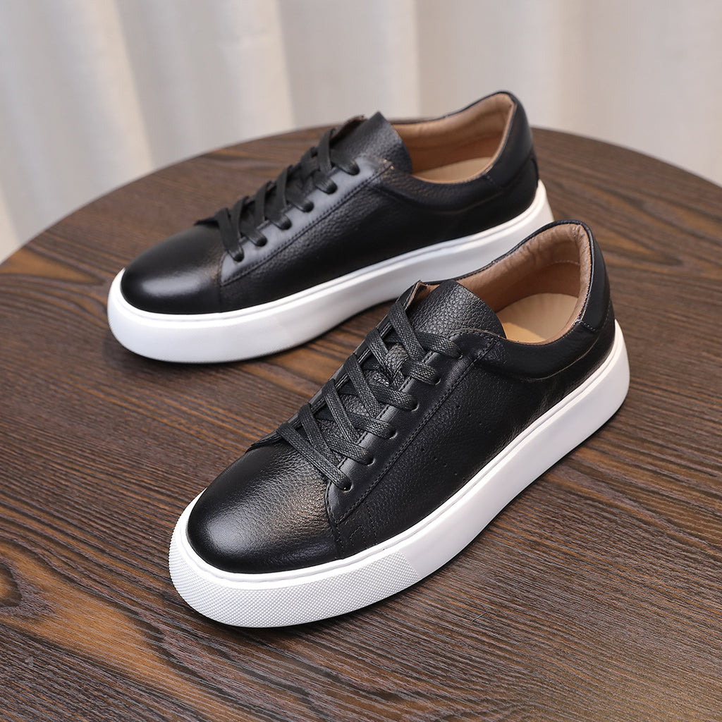 Black leather low-top sneakers, lace-up with white midsole and rubber outsole.