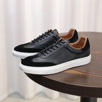 Men's black leather lace-up sneakers with low profile and white rubber midsole