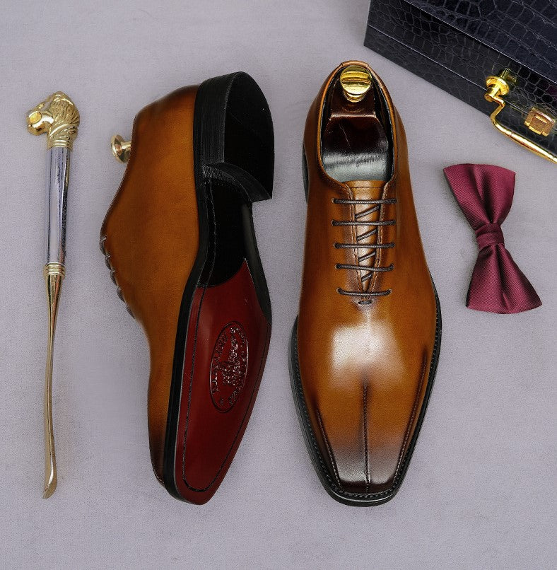 Men's brown lace-up wingtip brogue oxfords, side view with thick lug sole