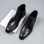 Black leather Chelsea dress boots with elastic side gore and perforated brogue detailing