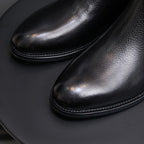 Pointed-toe Chelsea boots, black, close-up of smooth upper and stitched edge