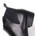 Close-up of black leather Chelsea boot side with elastic gore and stitching detail