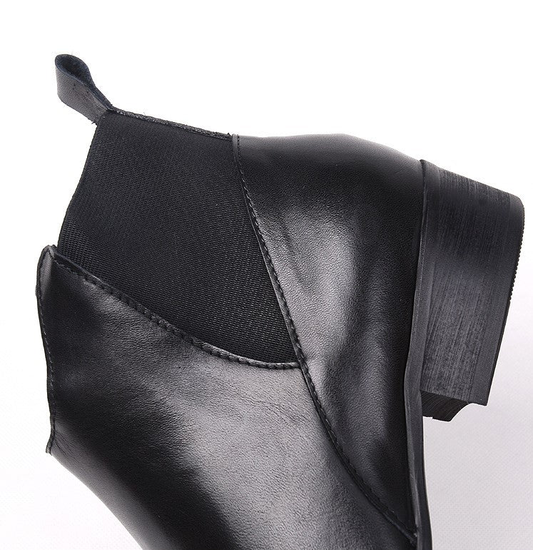 Close-up of black leather Chelsea boot side with elastic gore and stitching detail