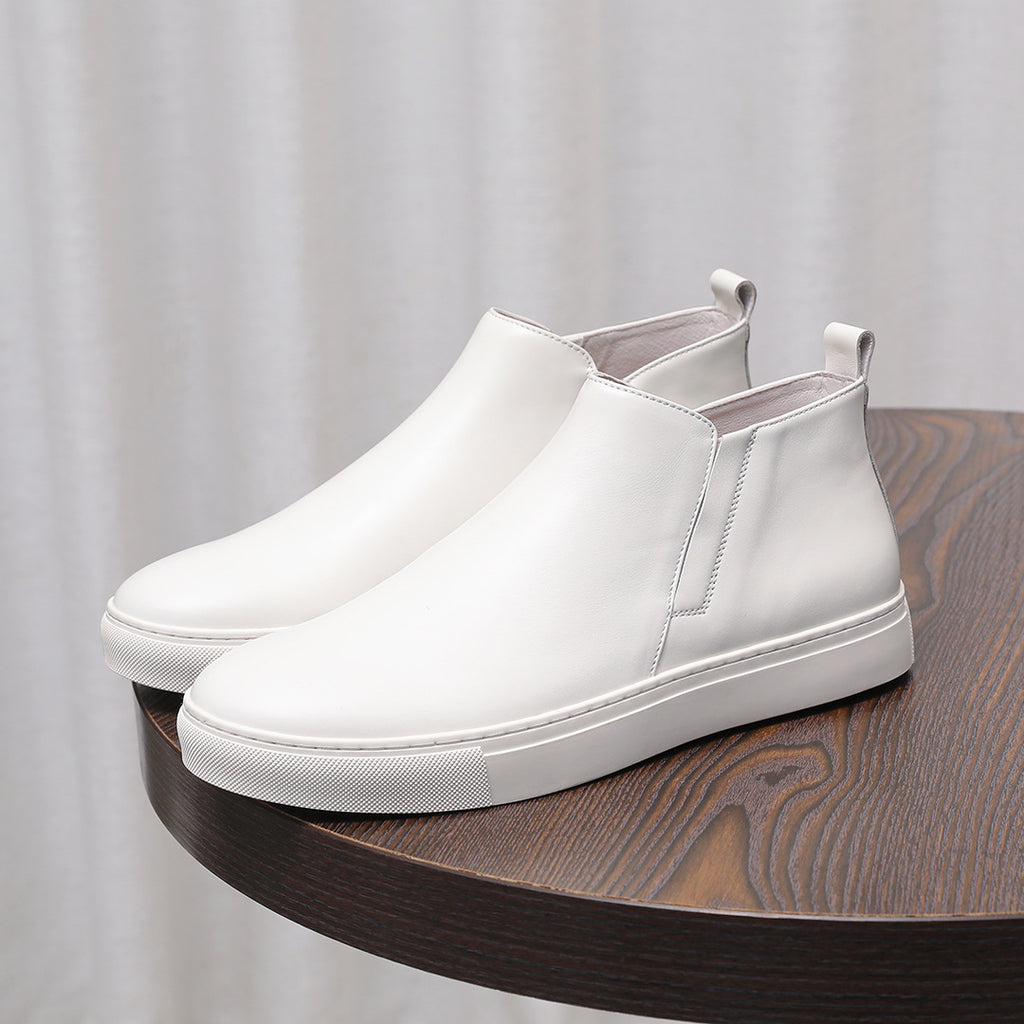 White leather pointed-cap toe side-zip dress boots with textured rubber sole