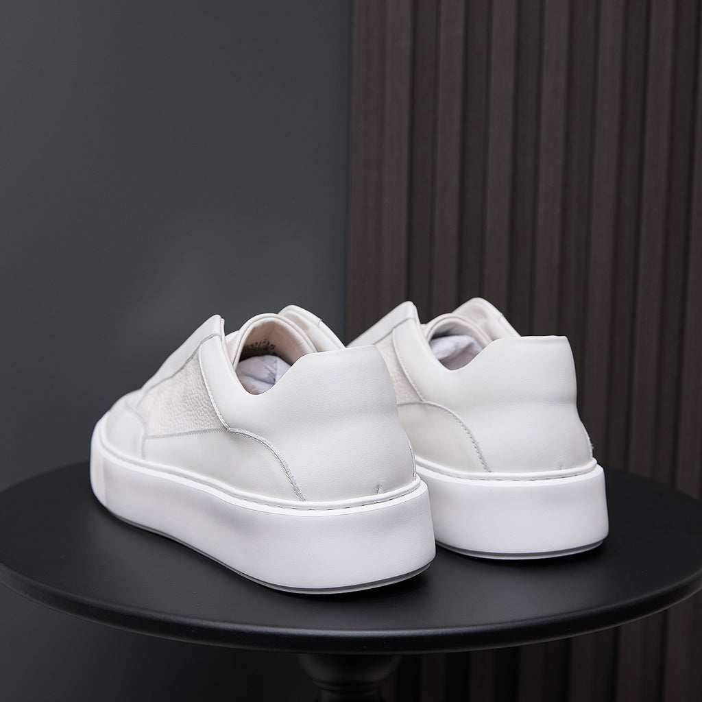 Back view of white genuine leather sneakers with padded heel and thick rubber sole