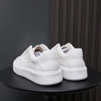 Back view of white genuine leather sneakers with padded heel and thick rubber sole