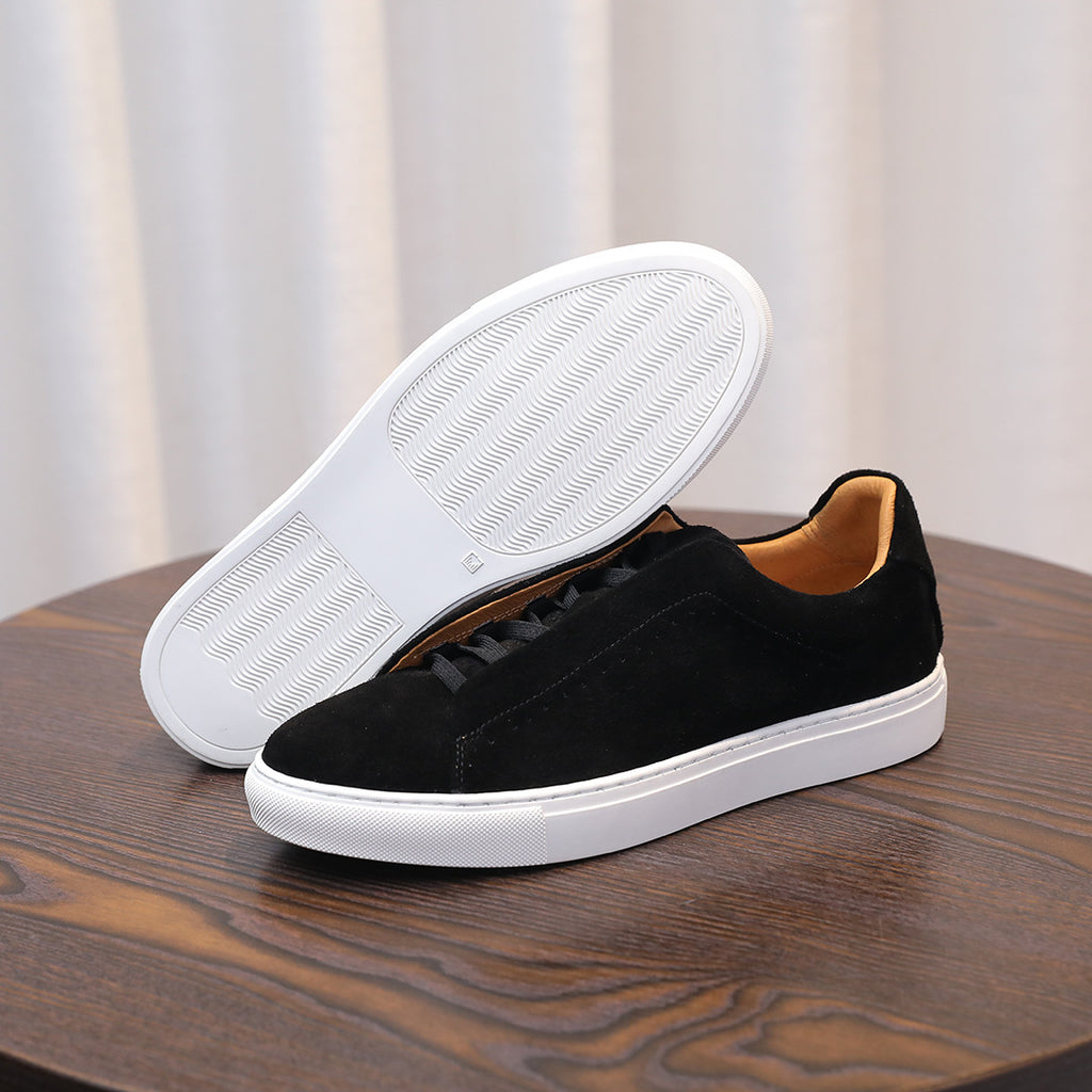 Men's black suede leather sneakers with textured white outsole, lace-up.