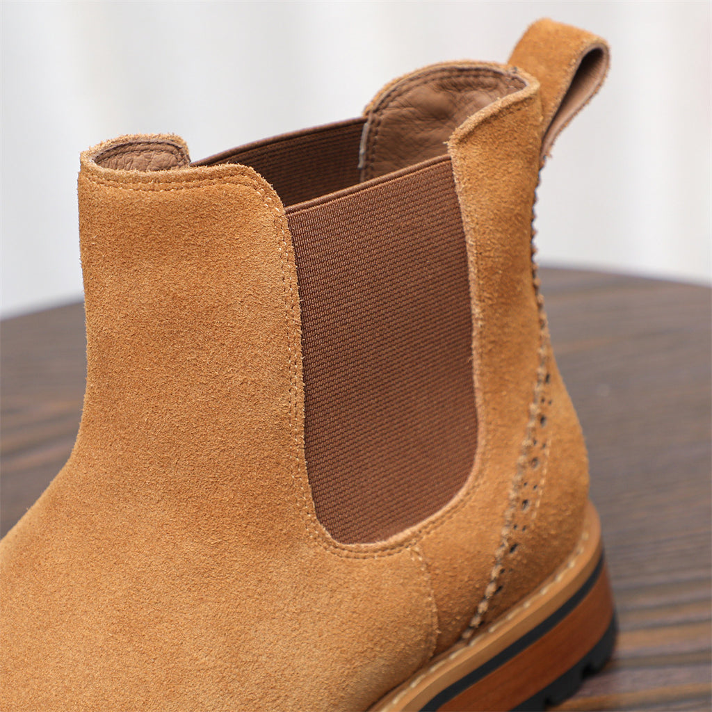 Close-up of brown suede Chelsea boot heel with elastic gore panel and stitch trim
