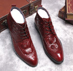 Men's burgundy lace-up dress boots with wingtip brogue detailing, glossy textured leather