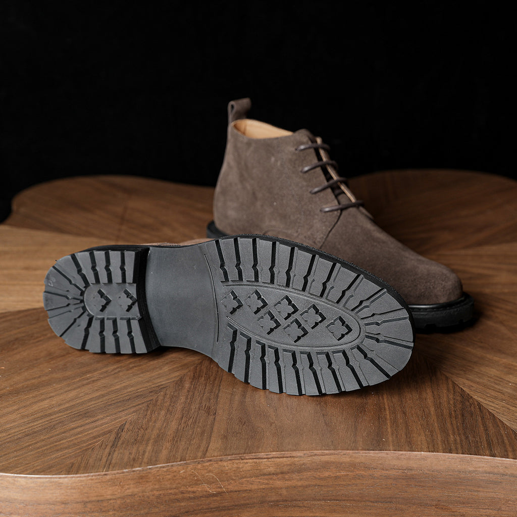 Men's dark brown suede chukka boot, side view, with rugged tread outsole