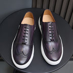 Purple leather lace-up sneakers, front view with white rubber soles