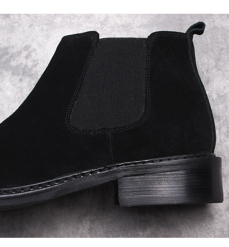 Men's black Chelsea dress boots, close-up of elastic gore and low stacked heel