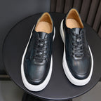 Men's leather sneakers in dark blue, lace-up with white rubber sole.
