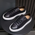 Black leather lace-up sneakers with white rubber midsole and textured side panel